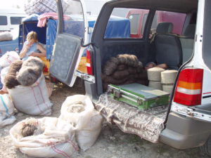 Balls of wool and yarns at display in trunk at Kosiv Market - Ukraine