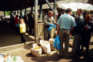 Farmer selling Kukruza - Mamaliga - Polenta at Zabolotiv Market, Ukraine