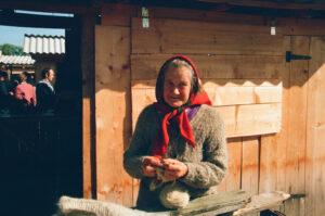 Ukrainian baboushka knitting and selling wool socks and jackets at Kosiv Market - Ukraine