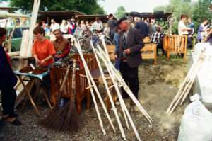 Craftsmen selling wooden skythe trees at Zabolotiv Market, Ukraine