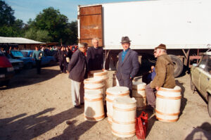 Craftsmen selling handmade barrels at Zabolitiv Market, Ukraine